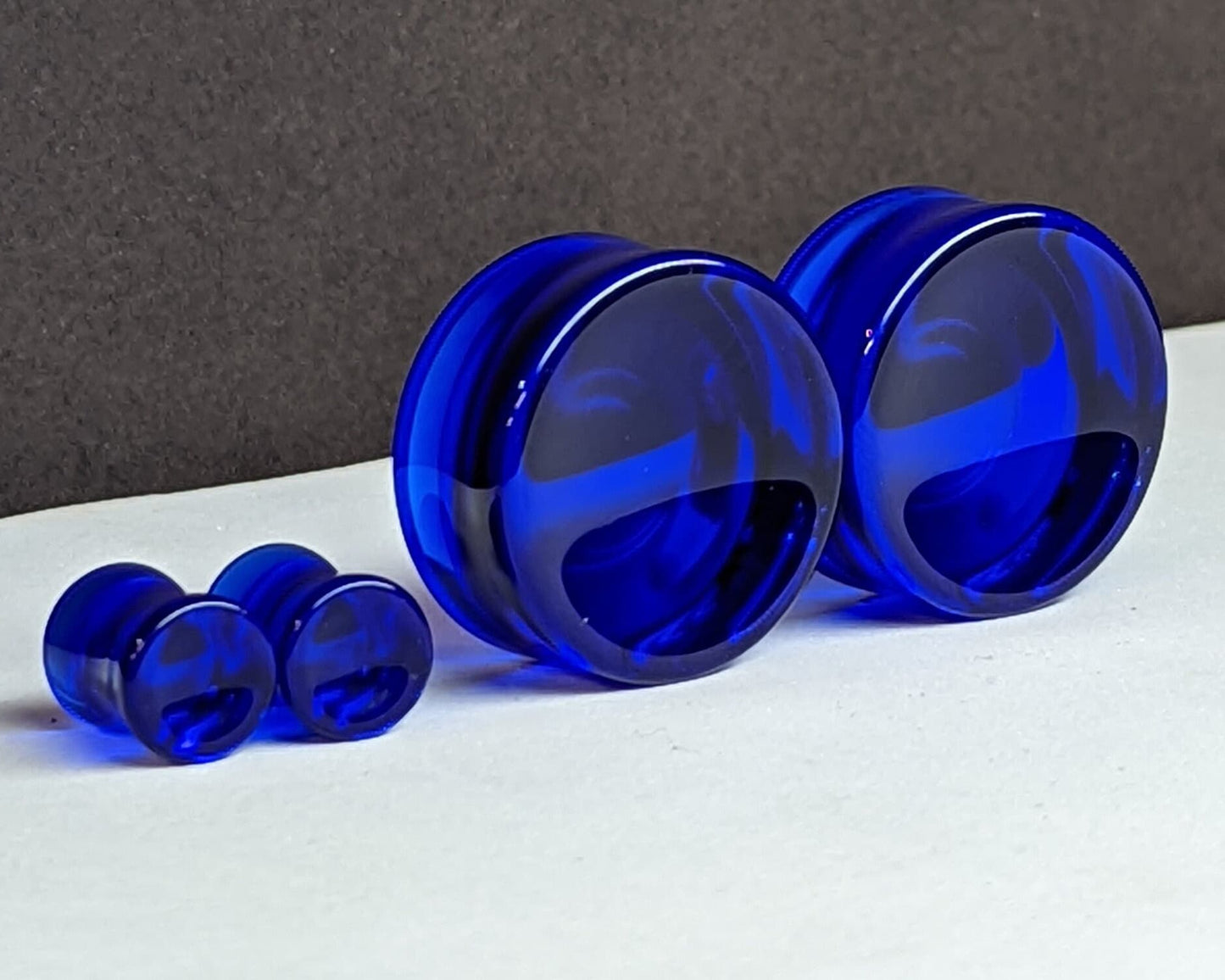 Concave Dark Blue Glass Plugs for stretched ears.