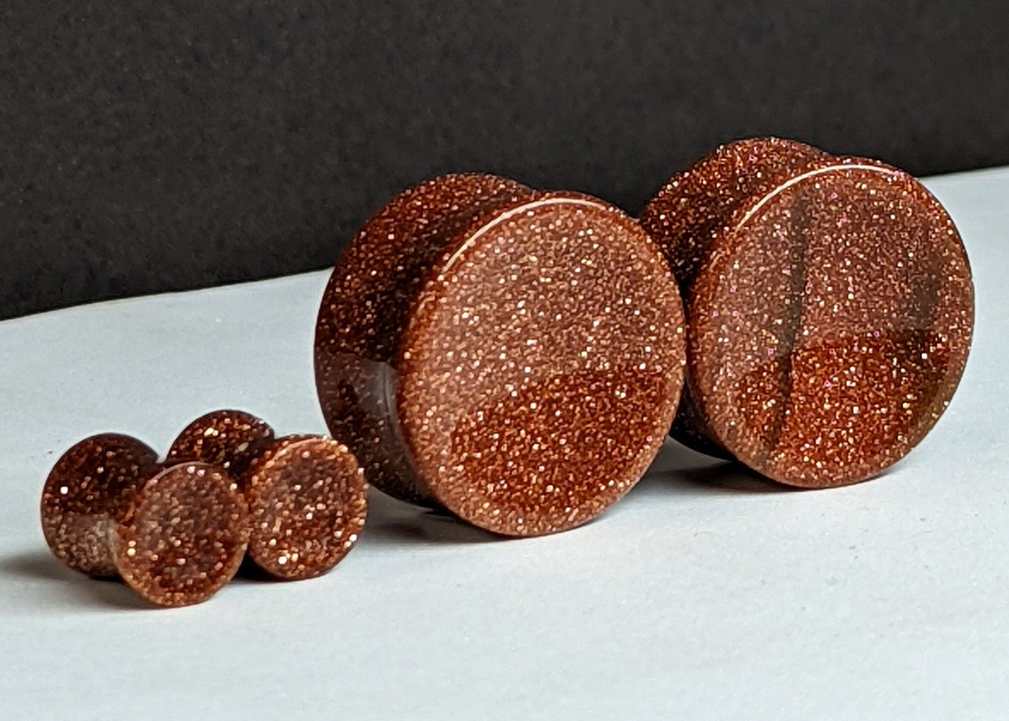 Concave Goldstone Glass Plugs for stretched ears.
