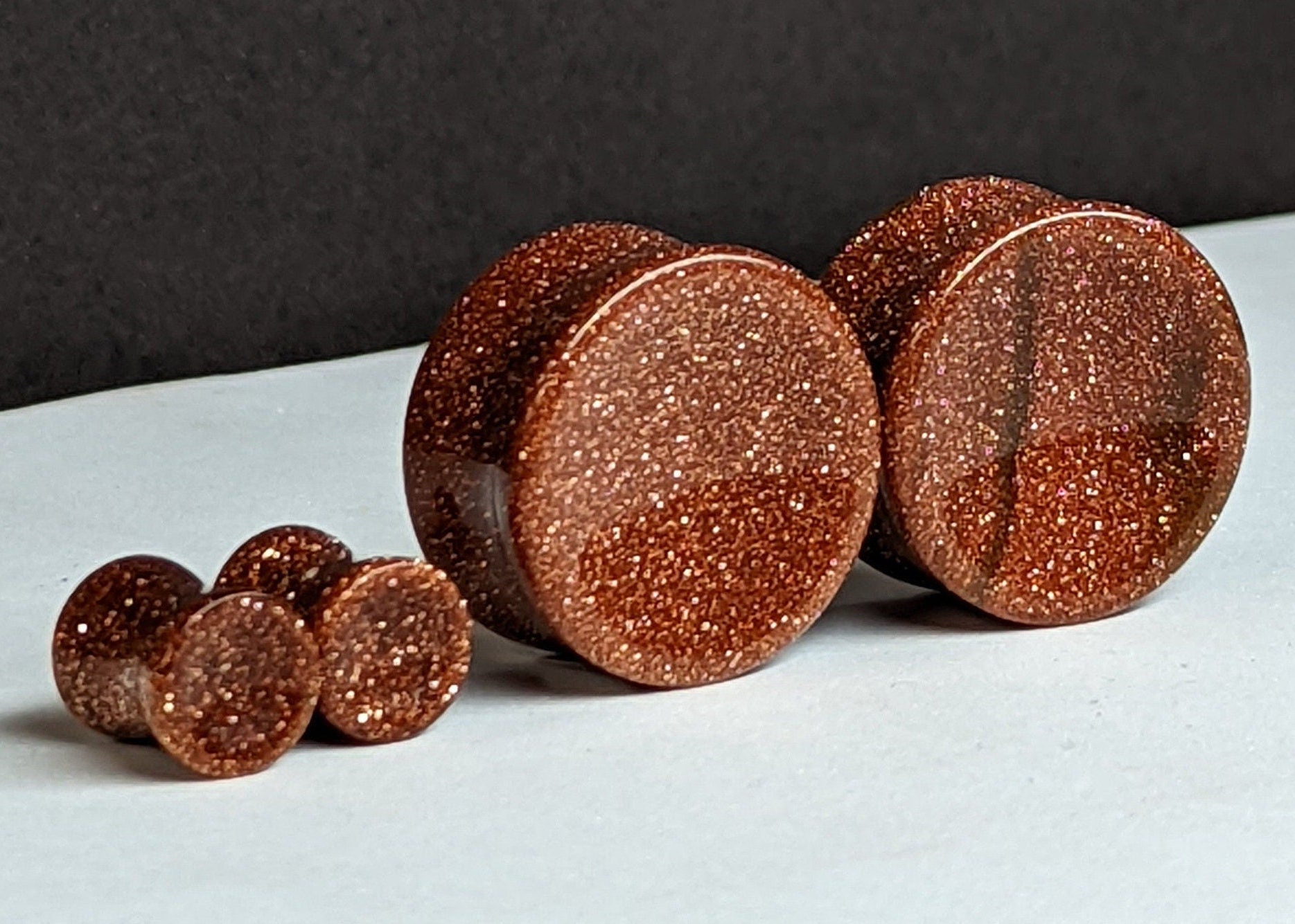 Concave Goldstone Glass Plugs for stretched ears.