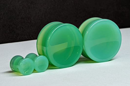 Concave Light Green Glass Plugs for stretched ears. 