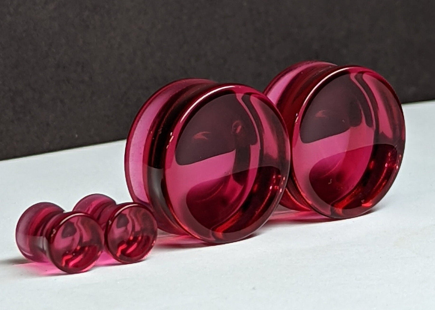 Concave Pink Glass Plugs for stretched ears.