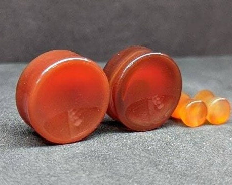 Concave Red Agate stone plugs for stretched ears. 