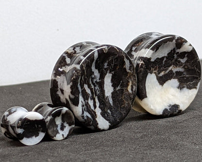 Concave Zebra Stone Plugs for stretched ears.