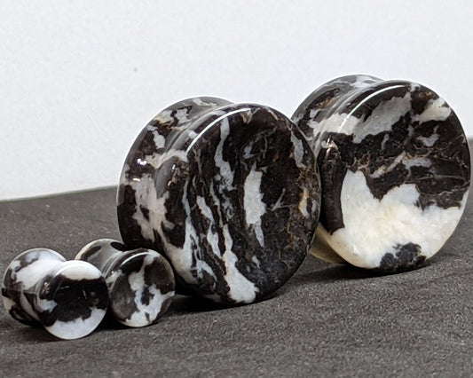 Concave Zebra Stone Plugs for stretched ears.