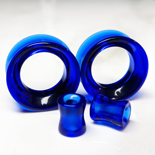 Dark blue glass tunnels for stretched ears.