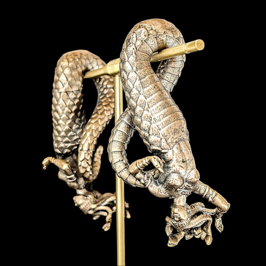 Medusa Ear Weights in bronze and sterling silver for stretched ears. Medusa hangs upside down from her tail from your lobe. 